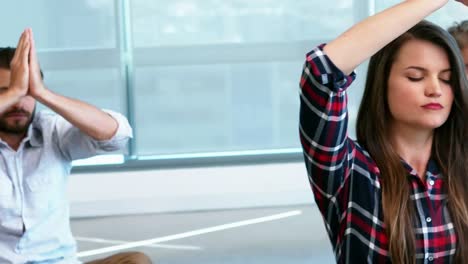 Colleagues-performing-yoga-in-the-office