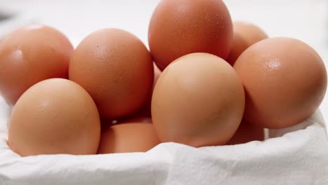 organic fresh several eggs in a rotating container on white wrapping paper for making food