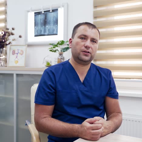 doctor consults patients through the camera. professional male therapist talking about possible ways of health treatment while sitting in clinic. telemedicine concept.