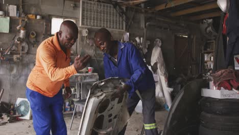 African men sanding a car