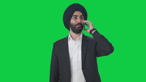 Happy-Sikh-Indian-businessman-talking-on-call-Green-screen