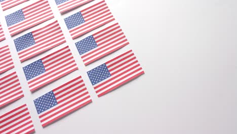 Multiple-national-flags-of-usa-lying-with-copy-space-on-white-background
