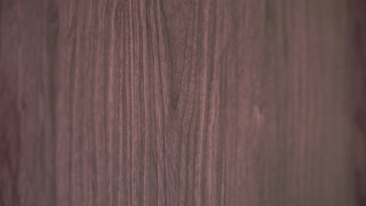 Close-up shot of a human knocking hand that hesitates to knock on a wooden door.Not so knocking on the door