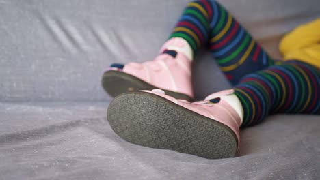 child wearing orthopedic shoes and striped tights