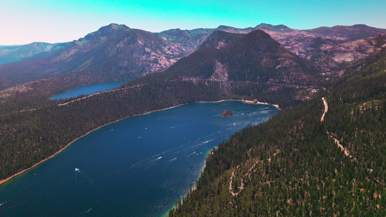 Tremendous view of beautiful Lake Tahoe surrounded by Sierra Nevada mountains. Stunning wildlife panorama at the backdrop of blue sky.