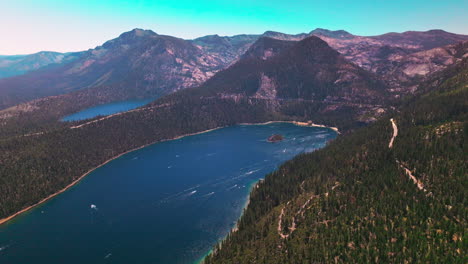 tremendous view of beautiful lake tahoe surrounded by sierra nevada mountains. stunning wildlife panorama at the backdrop of blue sky.