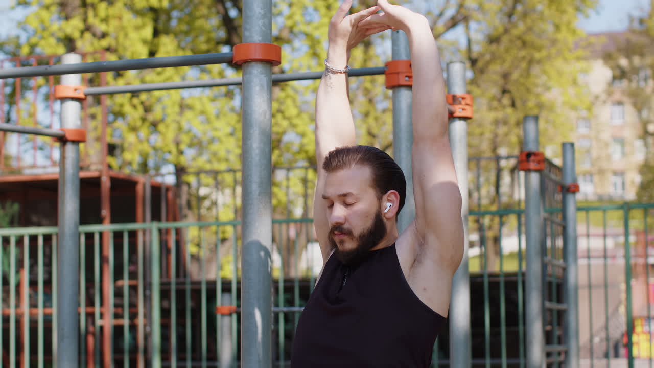 Athletic lebanese man in sportswear stretching body and warm up before cardio workout exercises