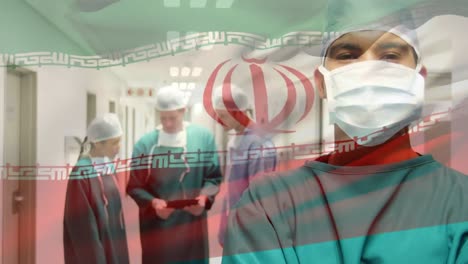 Animation-of-flag-of-iran-waving-over-surgeons-in-operating-theatre