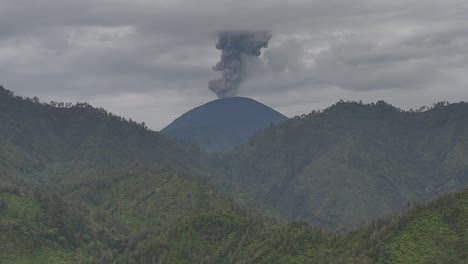 aerial drone view of an active volcano erupting ash cloud in east java indonesia