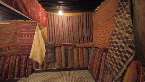 wonderful selection of hanging rugs for sale in shop.beautiful colorful patterned rugs hanging from the walls.