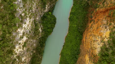 Spiraling-top-down-view-of-the-gorgeous-turquoise-green-Nho-que-river-in-the-lush-green-mountain-slopes-in-norther-Vietnam