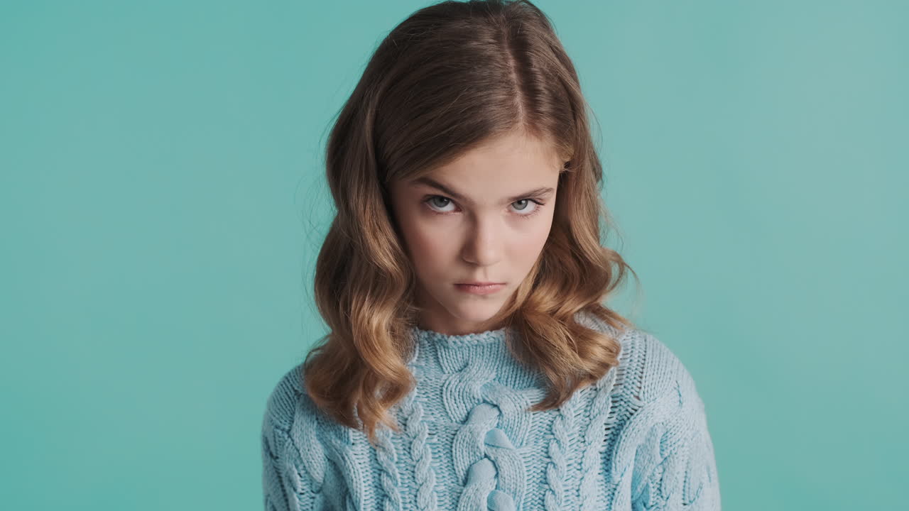 Teenage Caucasian girl looking sad in front of the camera.