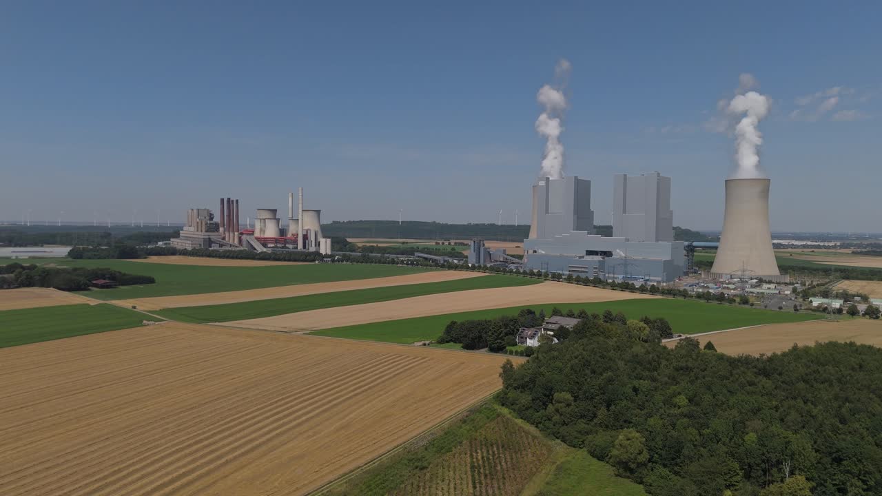 Neurath Power Plant Station In Smoke Billowing Cooling Towers In Grevenbroich, North Rhine-Westphalia, Germany