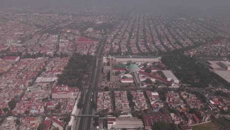 very polluted day in mexico city, the national the general archive of the nation is visible.