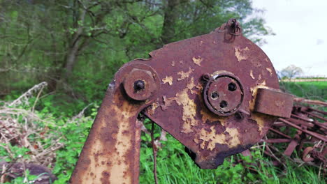 slow pan shot of discarded farm equipment