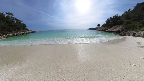 The-Iconic-Marble-Beach,-Slow-Walk-Along-The-Seaside,-Turquoise-Clear-Water,-Rocky-Hills-And-Green-Vegetation,-Thassos,-Greece