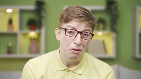 close-up of sad young man looking at camera.