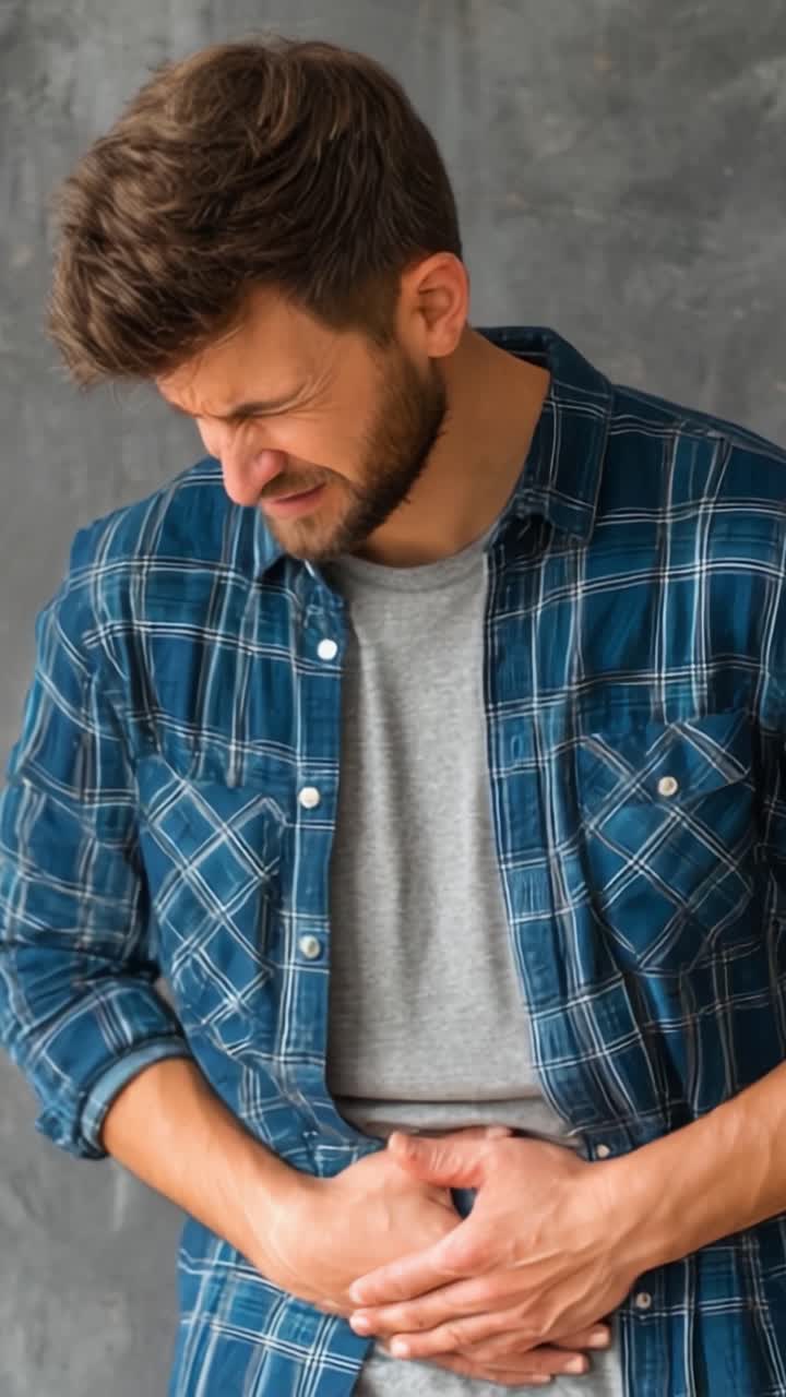 Man Experiencing Discomfort: A Closer Look at Abdominal Pain and Its Impact on Daily Life, as Reflected in Two Expressive Frames of Physical Distress