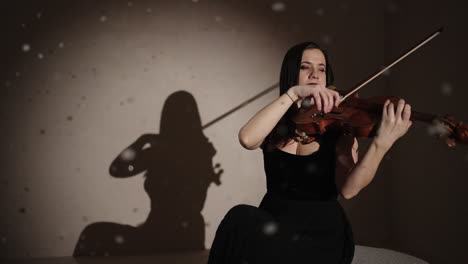 violinist in a dark studio with snow