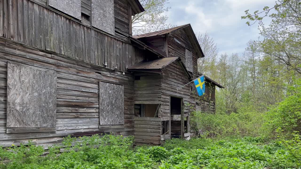 Swedish flag on the wall of an abandoned house on Vormsi Island. Estonia.