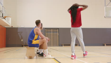 playing basketball in gym, team practicing drills and preparing for game