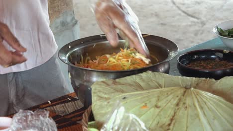 mixing ingredients in a metal bowl at a khmer cooking class in cambodia