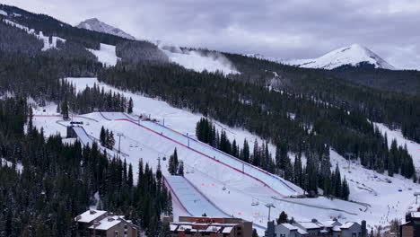 snow making half pipe big air jump ski snowboard gondola ski lift aerial drone cinematic copper mountain base colorado winter december christmas ski runs trails landscape rocky mountains circle left