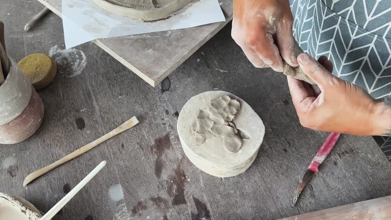 Close-up of Artist's Hands Pressing Clay into a Mold