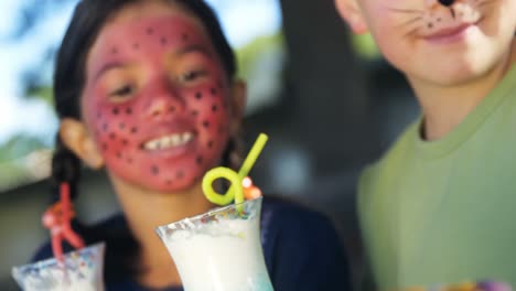 kids having sweet food and drinks in the playground 4k