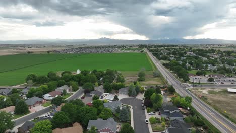 roadside shot leaving town along the highway from a drone at about 150 feet. longs peak visible in distance
