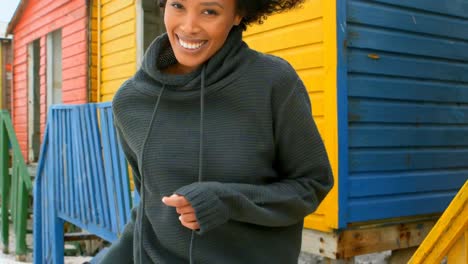 happy young african american woman dancing at beach hut 4k