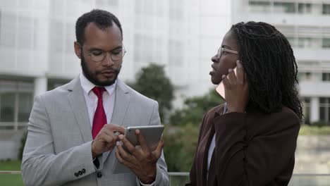 cheerful marketologists with digital devices working outdoor