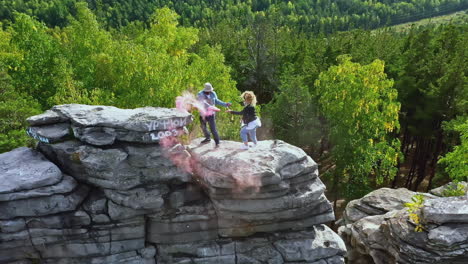 couple celebrating on a rocky mountain peak