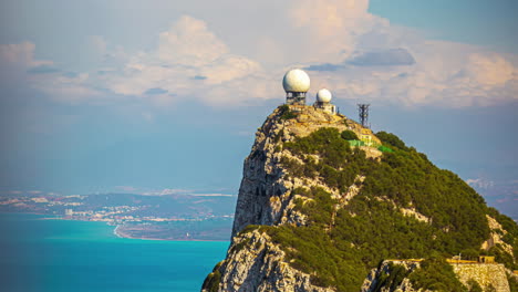 timelapse of moving clouds above radar station at the top of the rock of gibraltar