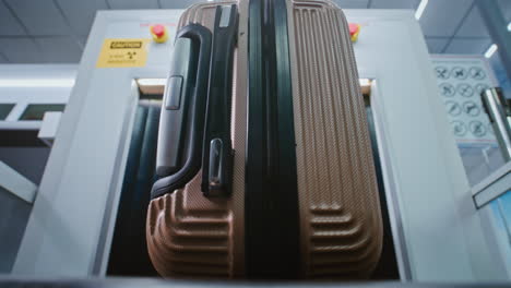 airport security x-ray scanner with suitcase