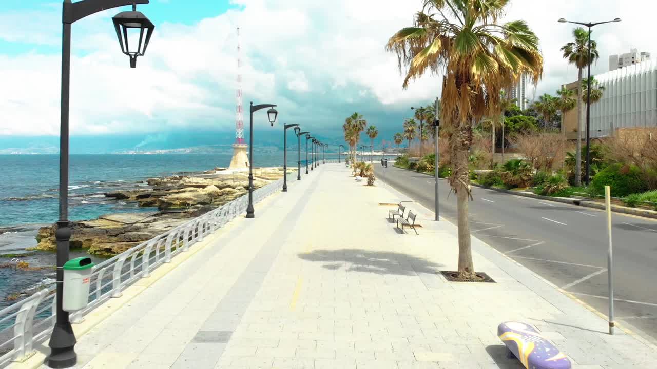 Fly over Beirut's famous Manara with this captivating drone video. See bustling streets, and the expansive blue ocean meeting the city's edge. Perfect for travel.