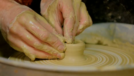 professional male potter making mug in pottery workshop