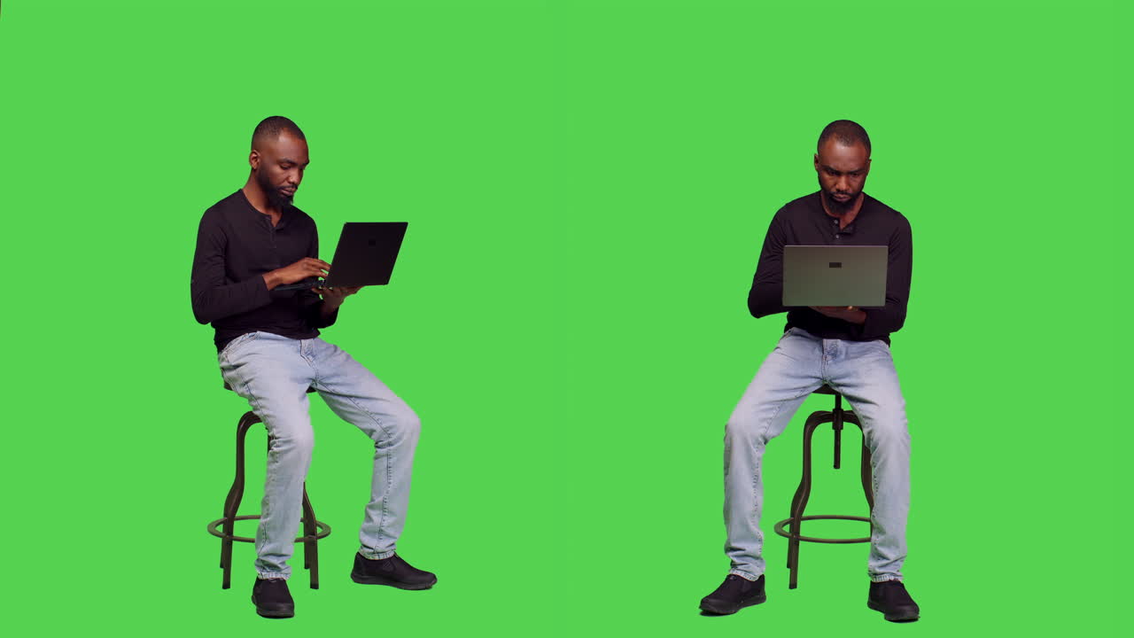 Man Sitting on Stool Using Laptop in Studio