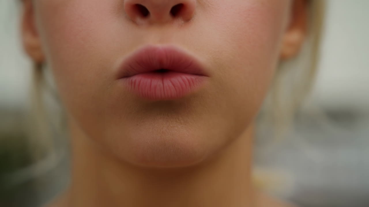 Close-up of Woman's Lips Puckering for a Kiss