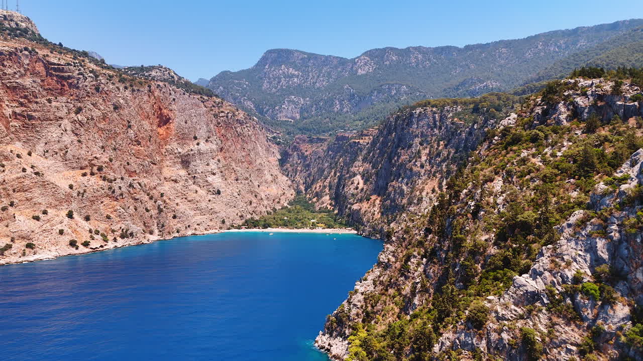 Spectacular bare rock with unapproachable cliffs. Drone footage above the Mediterranean Sea surrounded in Turkey