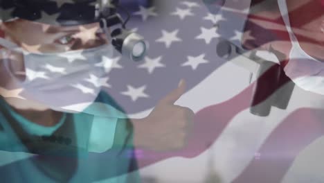 animation of flag of usa waving over surgeons in operating theatre