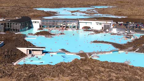 Aerial arcing shot of people relaxing in the world famous Blue Lagoon Resort