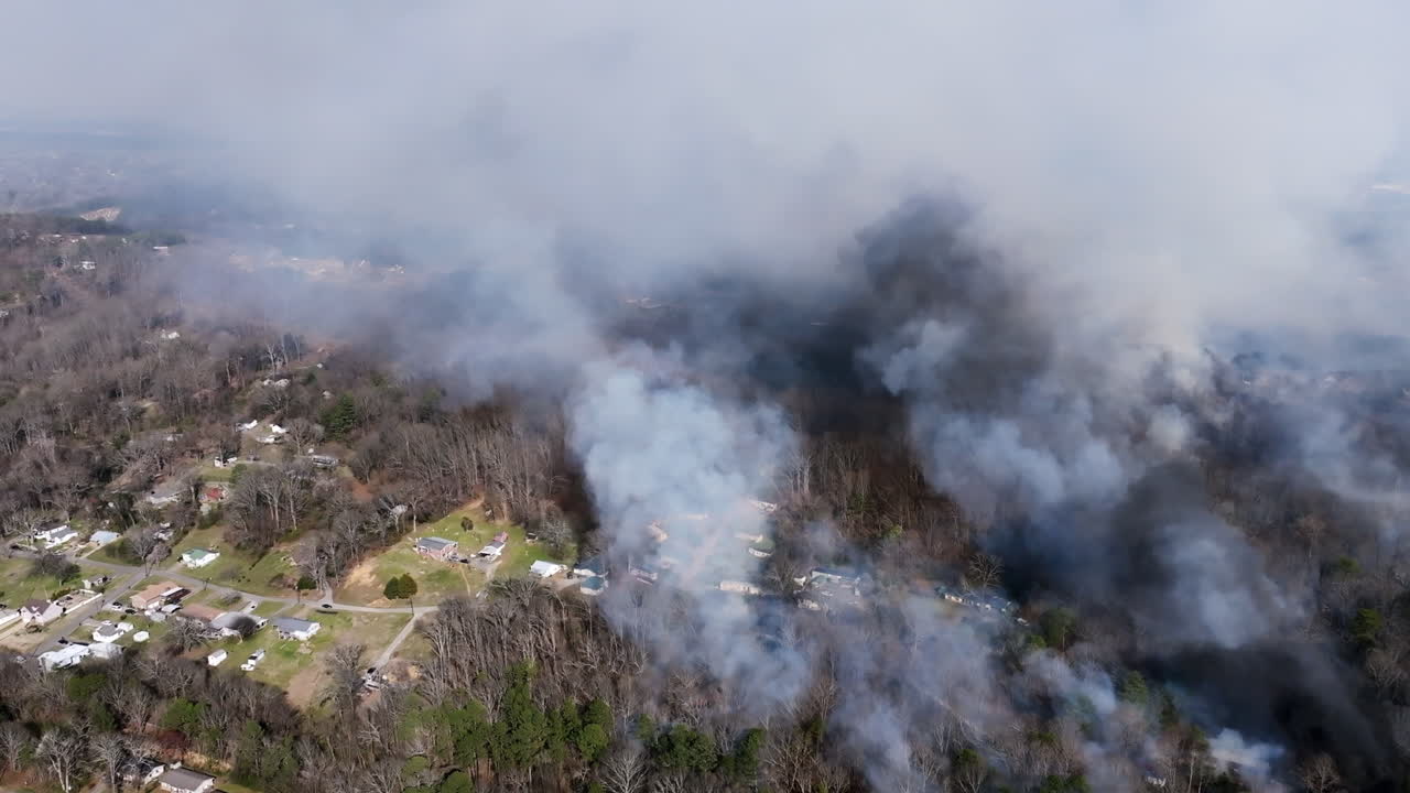 Aerial footage rotating around neighborhood in Georgia where a forest fire is encroaching.