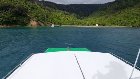 a view from the bow of a ferry as it arrives at ship cove at the top of the south island of new zealand