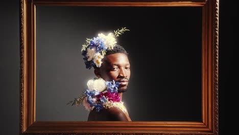 portrait of black man wearing floral arrangement inside frame