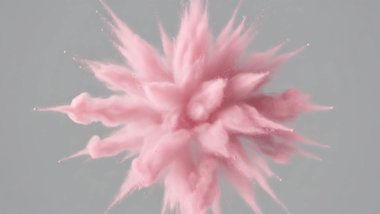 Esplosione di polvere rosa in espansione su uno sfondo grigio neutro