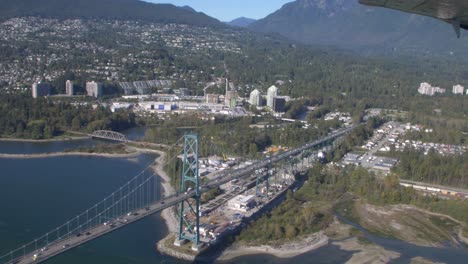 rare aerial over the lions gate bridge from a float plane