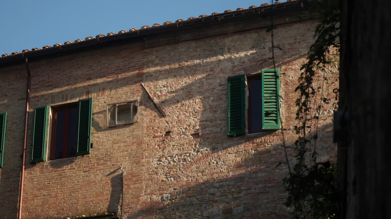 Charming Italian-style house with rustic stone walls, terracotta roof, and wooden shutters. This cozy countryside home captures the essence of traditional Italian architecture.