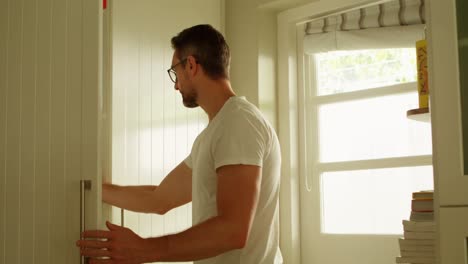 man taking out wine bottle from wardrobe 4k