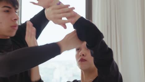 duet dancing contemporary with arms entwined in studio